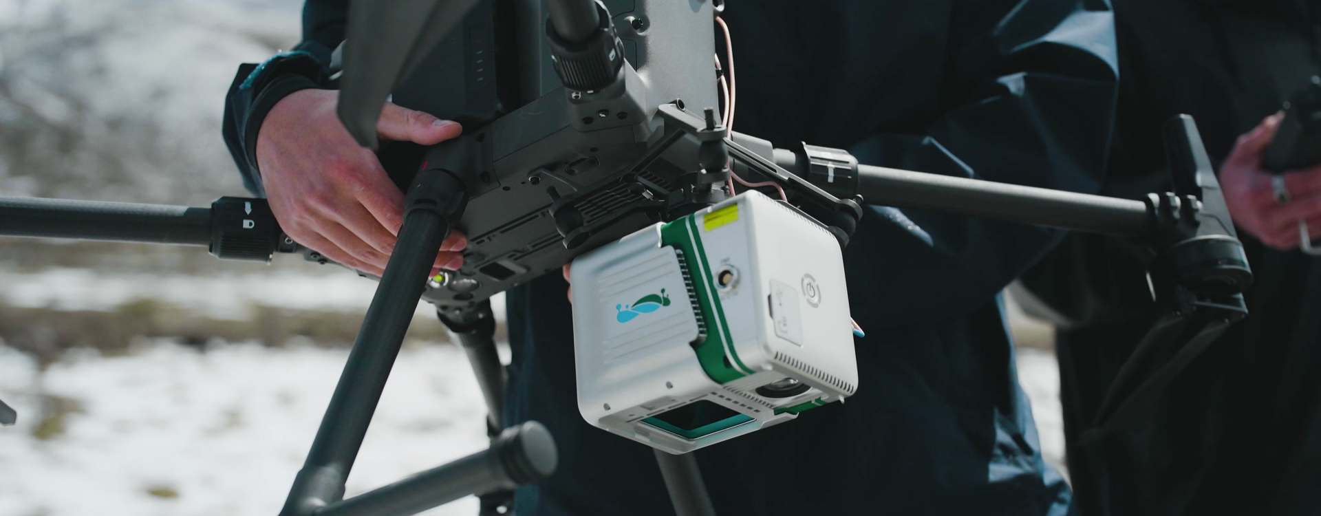 LiAir X3-H UAV LiDAR payload being mounted on drone in snowy field